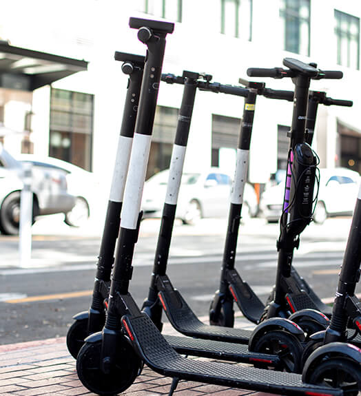 Electric scooters parked on a sidewalk