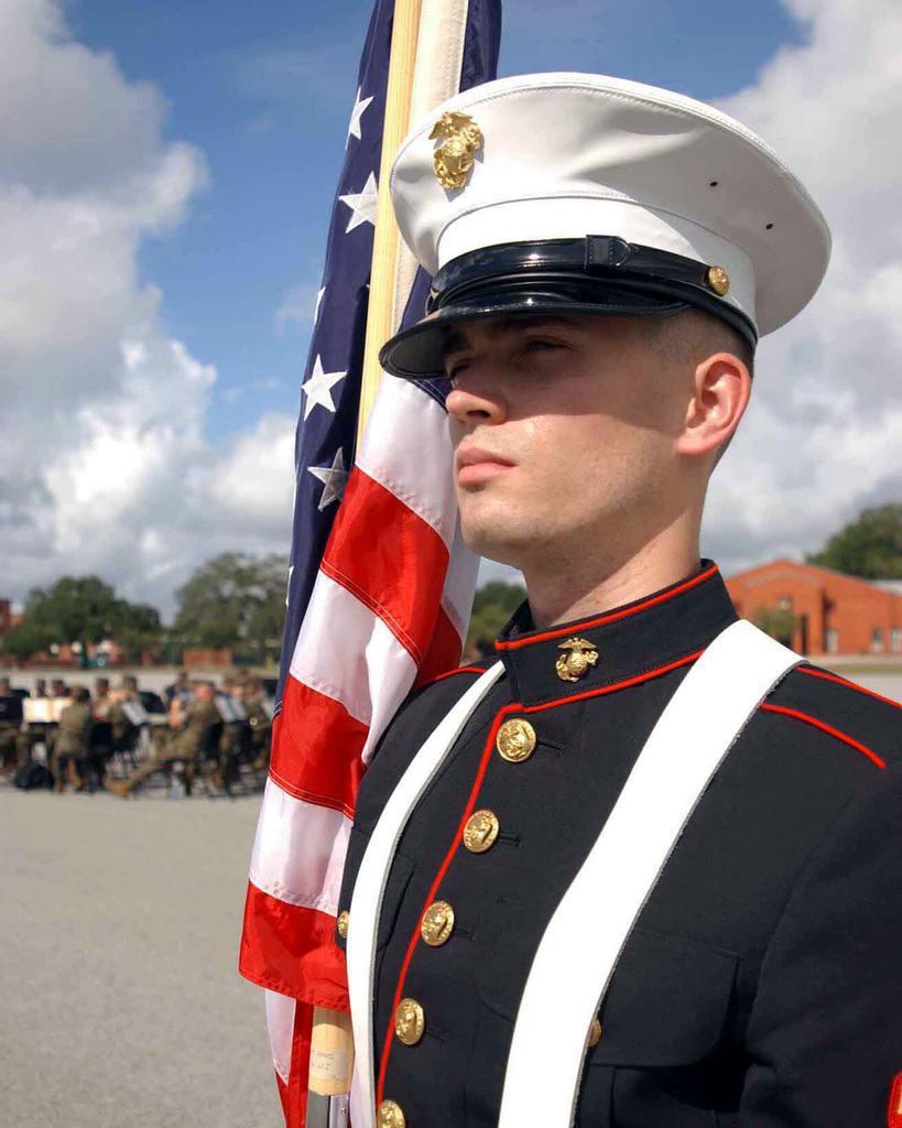 US Marine standing by American flag at camp lejeune